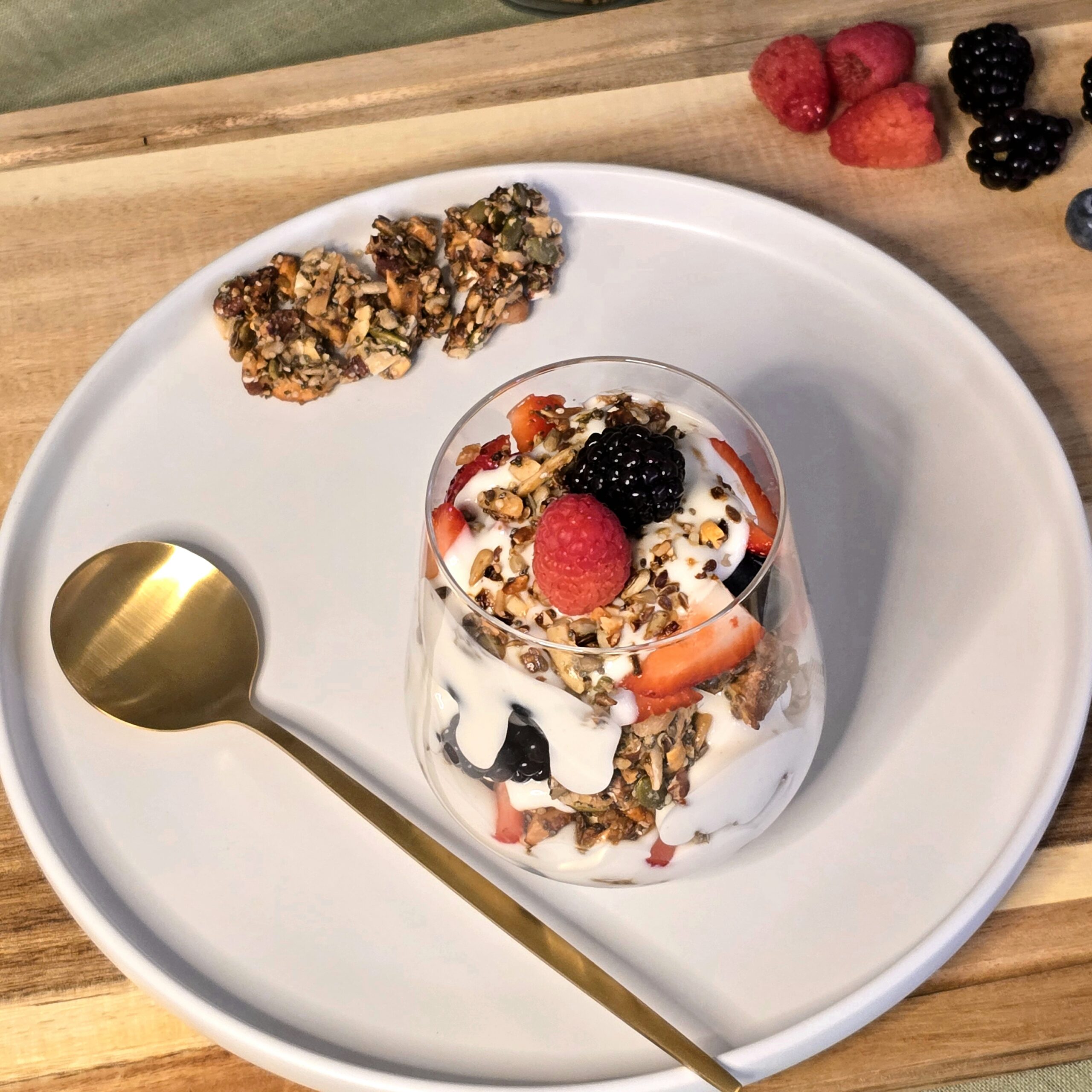 Seeded brittle and berry yogurt parfait layered with coconut yogurt and fresh berries